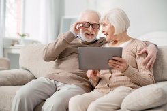 altes Ehepaar auf Couch mit Tablet